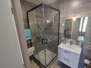 a bathroom with a glass shower and a sink at La Maison de Raph in Villeneuve dʼOlmes +30 photos
