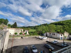 a parking lot with cars parked in a parking lot at La Maison de Raph in Villeneuve dʼOlmes