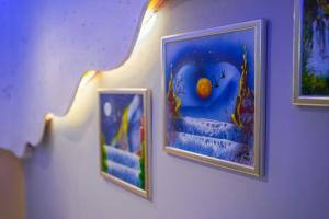 two framed pictures on a wall with an orange on it at Apartments Villa Tomaš in Brela