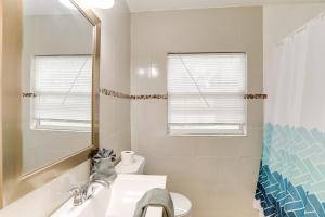 a bathroom with a sink and a toilet and a mirror at Clearwater Vacation Rental Near Downtown and Beaches in Clearwater +18 photos
