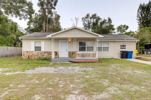 a small white house with a yard at Clearwater Vacation Rental Near Downtown and Beaches in Clearwater