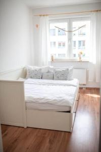 a white bed in a room with a window at Zentral Bahnhof Apartment# Ntfx# in Halle an der Saale
