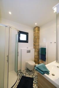 a bathroom with a shower and a toilet and a sink at Keros Bay View in Kalliópi