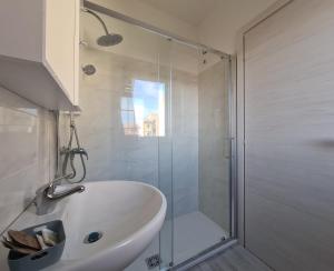 a bathroom with a shower and a white bath tub at Civico 14 Apartment 3 in Monserrato