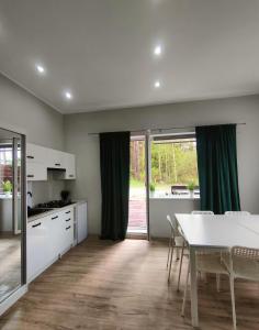 a kitchen and dining room with a table and chairs at Apartament Baranek Nad Jeziorem in Gostycyn