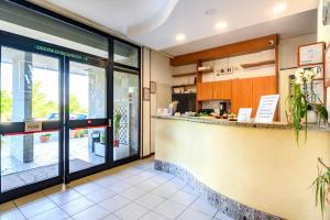 a restaurant lobby with a counter and a kitchen at Hotel Anna Siena Nord in Siena