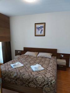 a bedroom with a bed with two towels on it at Belvedere Holidey Clab apartament L403 in Bansko