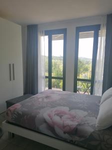 a bedroom with a bed and a window with a view at IL CILIEGIO DI ZOE in Cerro Lago Maggiore