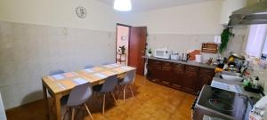 a kitchen with a table and chairs in a room at Chalé Seixal - Sea View in Seixal