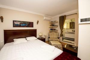 a hotel room with a bed and a television at Enchanting House with Backyard in Bodrum in Bodrum City