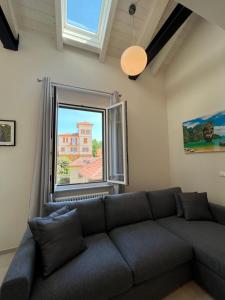 a living room with a couch and a large window at Tropicale in Rapallo