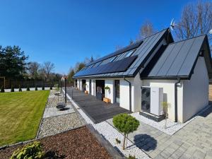 una casa con paneles solares en el techo en Koliberek Apartamenty en Polanica-Zdrój