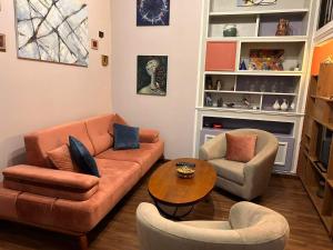 a living room with a couch and two chairs and a table at Aparthotel Mari in Tbilisi City