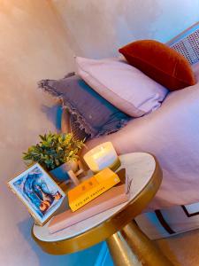 a bed with a table with books and a pillow at Beautiful Boho in Bridgend in Bridgend