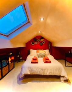a bedroom with a large bed with a red wall at Beautiful Boho in Bridgend in Bridgend
