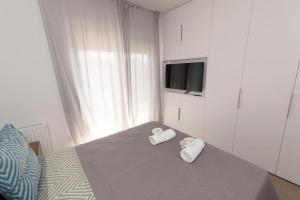 1 Schlafzimmer mit 2 Handtüchern auf einem Bett in der Unterkunft Modern apartment close to Athens city center (Form_F2) in Athen