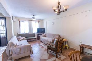 a living room with two couches and a tv at Wonderful Home Close to Beach in Fethiye in Fethiye