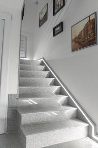 a stair case in a house with a picture on the wall at J&S Apartments in Niš