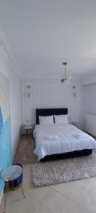 a bedroom with a large bed and a table at atoll 'Paris-Alexandre' in Gythio