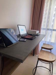 a desk with a laptop computer and a chair at Grays Hostel By Haly in Dubai