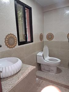 a bathroom with a toilet and a sink at Sandy Beach Resort & Restaurant in Cox's Bazar