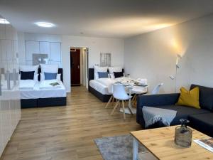 a living room with two beds and a couch and a table at 1-Zimmerapartment mit Burgblick in Bad Liebenzell
