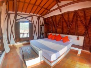 a bedroom with a bed in a room with a window at Cabañas el Nopal in San Gil