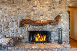 a stone fireplace with a fire in it at 3794 Forever Views II home in Carmel