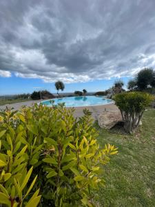 a swimming pool in the middle of a yard at Borgo alto - Ideal holiday for families & friends in Noto