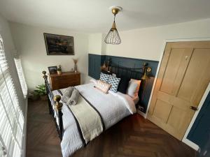 a bedroom with a bed with a wooden floor at The Railway Cottage Bridgnorth in Bridgnorth