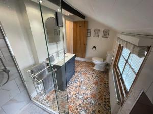a bathroom with a glass shower and a toilet at The Railway Cottage Bridgnorth in Bridgnorth +26 photos
