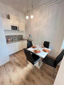 a dining room with a white table and chairs at TOP LOCATION in Vienna