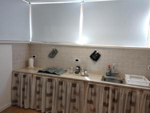a kitchen with a sink and a counter top at Casabella Mondello in Mondello