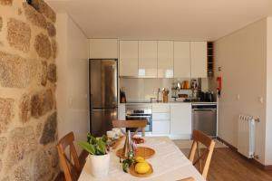 a kitchen with a table with fruit on it at Vila de Campos - Gerês in Vieira do Minho