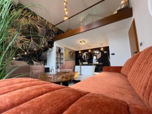 a living room with a couch and a table at Toplik Village Resort in Lukavica