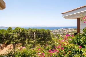 a view from the balcony of a house with flowers at Enchanting Villa with Backyard in Cesme near Beach in Alacati