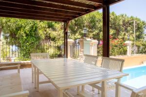 a white table and chairs on a patio at Enchanting Villa with Backyard in Cesme near Beach in Alacati