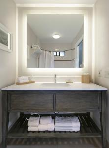 a bathroom with a sink and a large mirror at Cottage Inn by the Sea in Pismo Beach