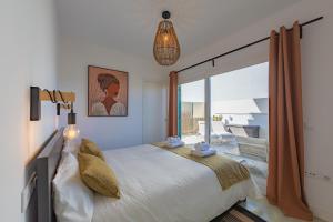 Un dormitorio con una cama grande y una ventana grande. en La Reserva Bajo E, en Tarifa