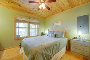 a bedroom with a bed and a ceiling fan at Blue Ridge Mountain Cabin with Views, 2 Mi to Dtwn! in Murphy