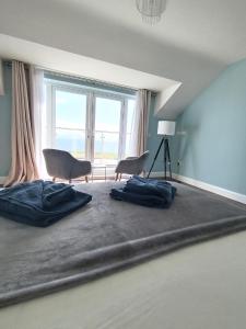 a room with two chairs and a large window at Vista Mara in Donegal