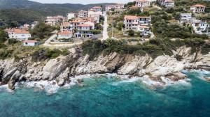 an aerial view of a village on a rocky cliff at Zennova #3 Mount Athos & Sea View in Pyrgadikia