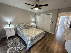 a bedroom with a bed and a ceiling fan at Suite 2 