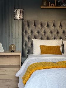 a bedroom with a large bed with a large headboard at LuxuryAirportLodge near OR TAMBO in Kempton Park