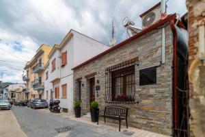 a bench sitting on a street next to a building at Infinity house kavala in Kavala