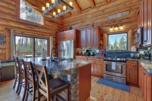 una cocina con una gran isla en una cabaña de madera en Grand Lake Cabin with Direct Access to Rocky Mtn NP!, en Grand Lake