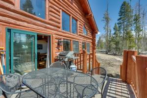 a wooden cabin with a table and chairs on a deck at Grand Lake Cabin with Direct Access to Rocky Mtn NP! in Grand Lake