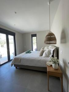 a bedroom with a large bed and a table at Myrtia Villas I in Anomeriá