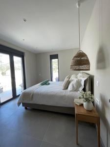 a bedroom with a large bed and a table at Myrtia Villas I in Anomeriá +33 photos