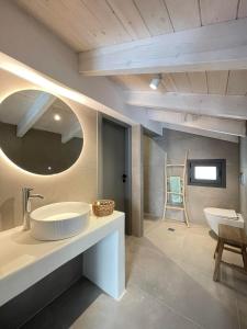 a bathroom with a sink and a mirror at Myrtia Villas I in Anomeriá